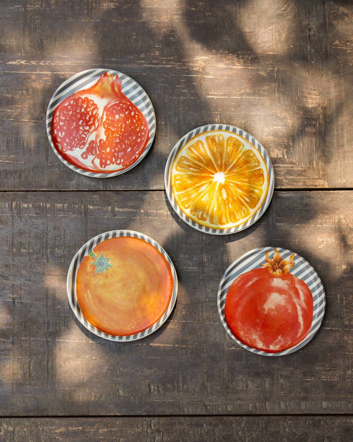 Four Nimbu & Anar coasters with pomegranate and citrus fruit prints.
