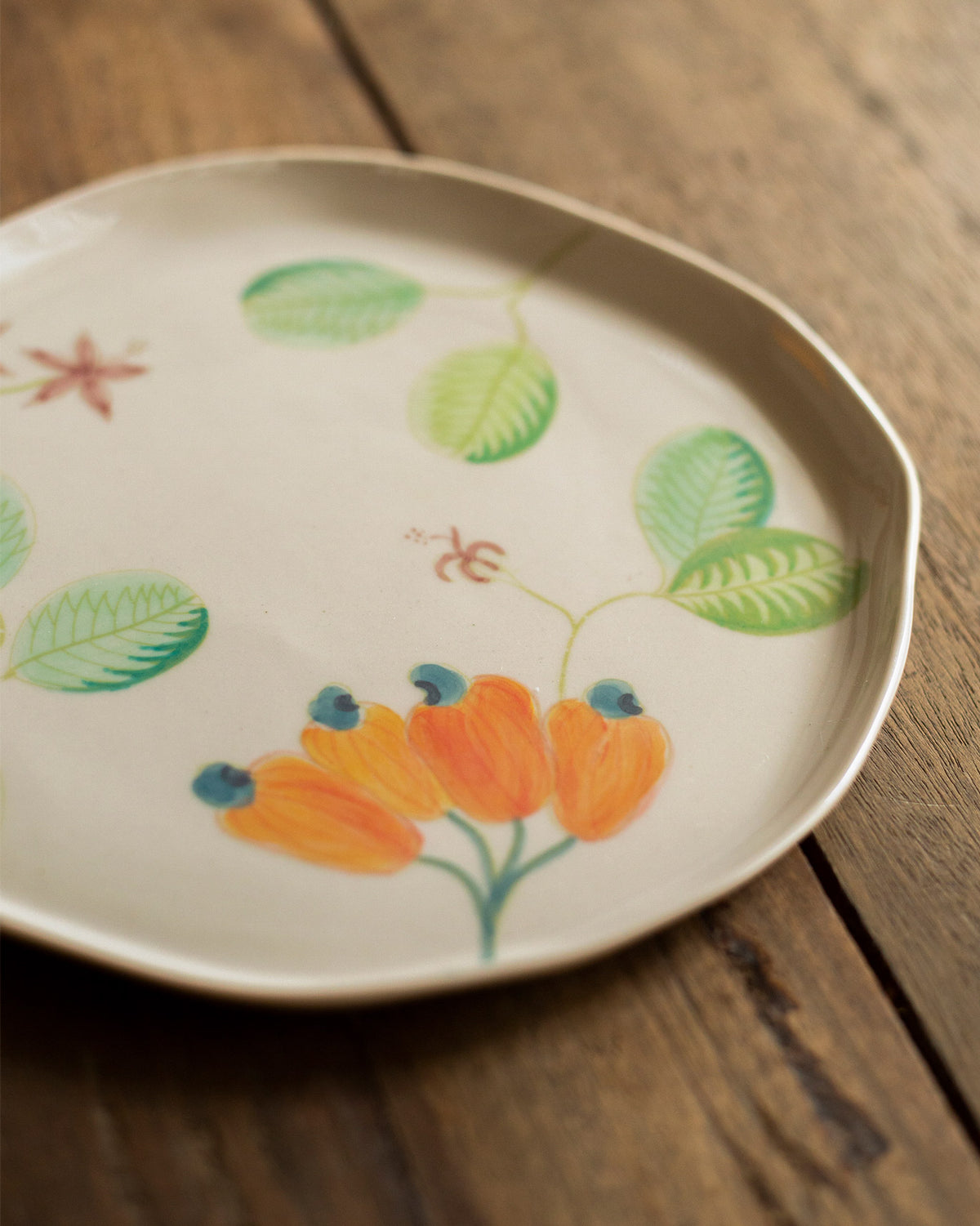 Close-up of a Mandovi quarter plate showing its orange flowers and leaves.