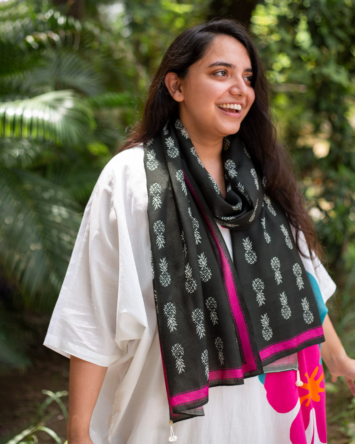 Person wearing a black Tropico Scarf with pink edges.