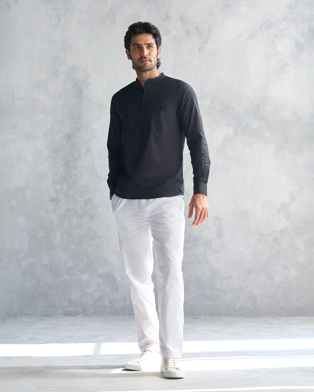 Full-length view of a black Pondicherry shirt worn by a person.