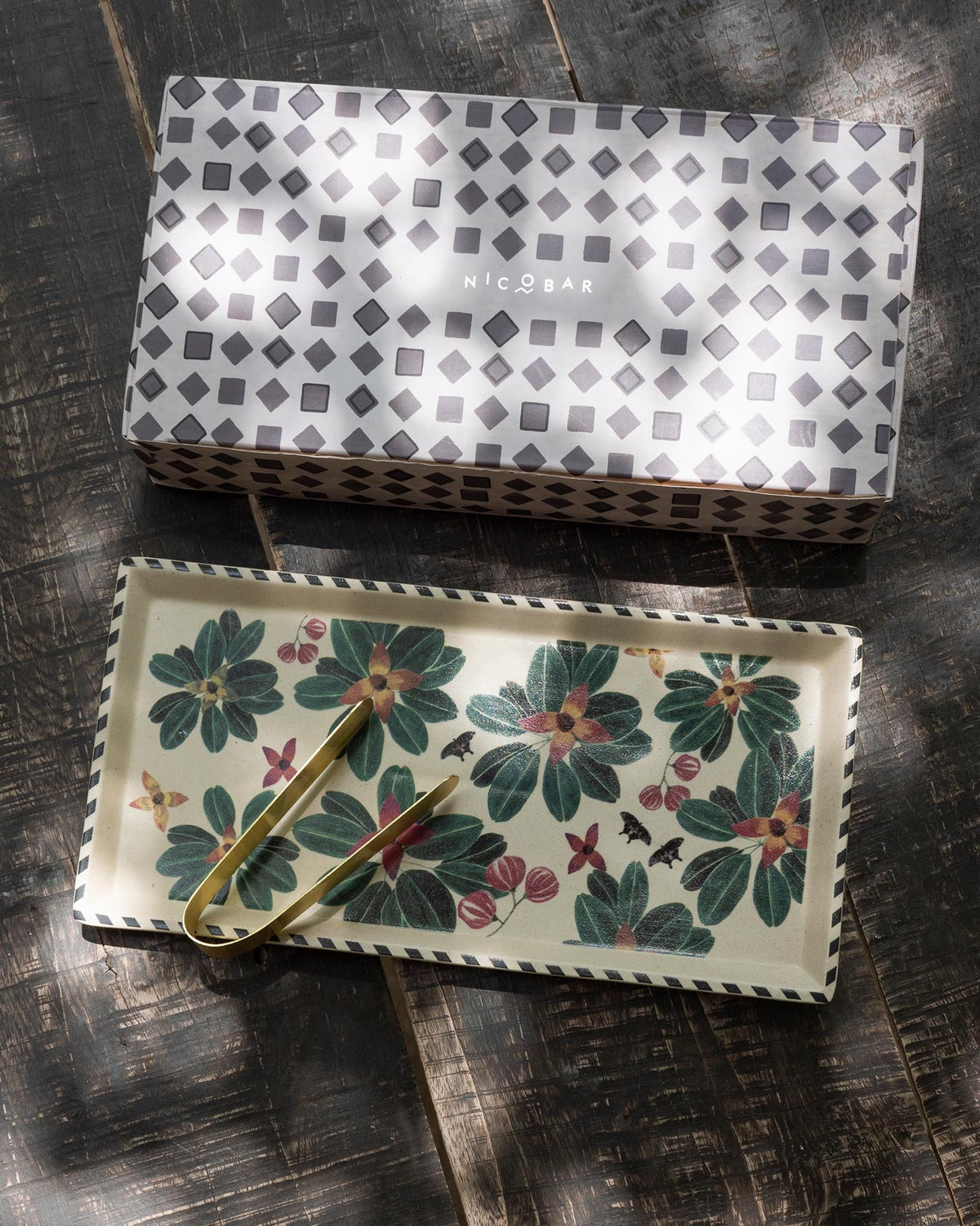 Flora Cookie Tray with Tong beside its grey geometric gift box.