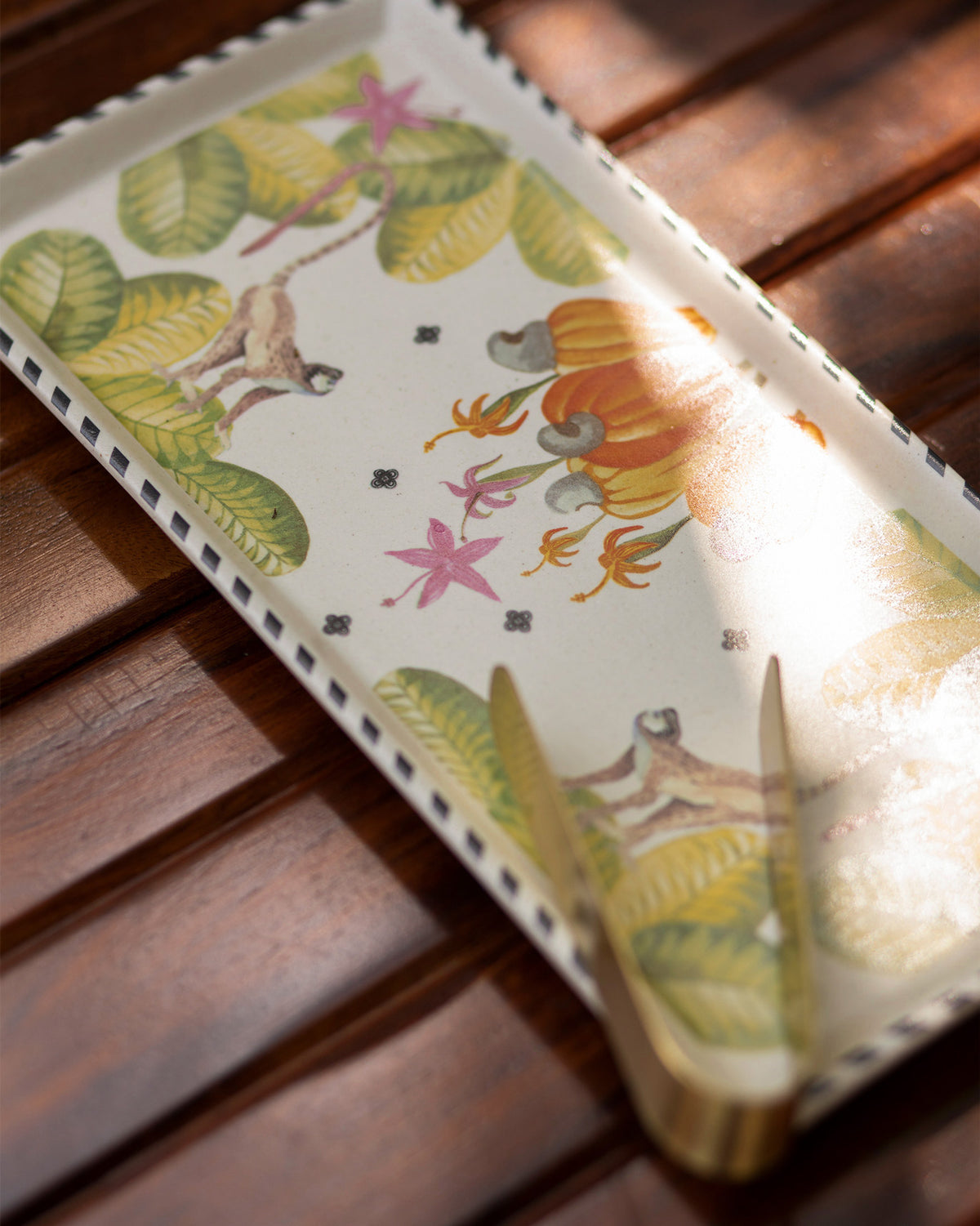 Close-up of the Mahi Cookie Tray showing its monkey and fruit motifs.