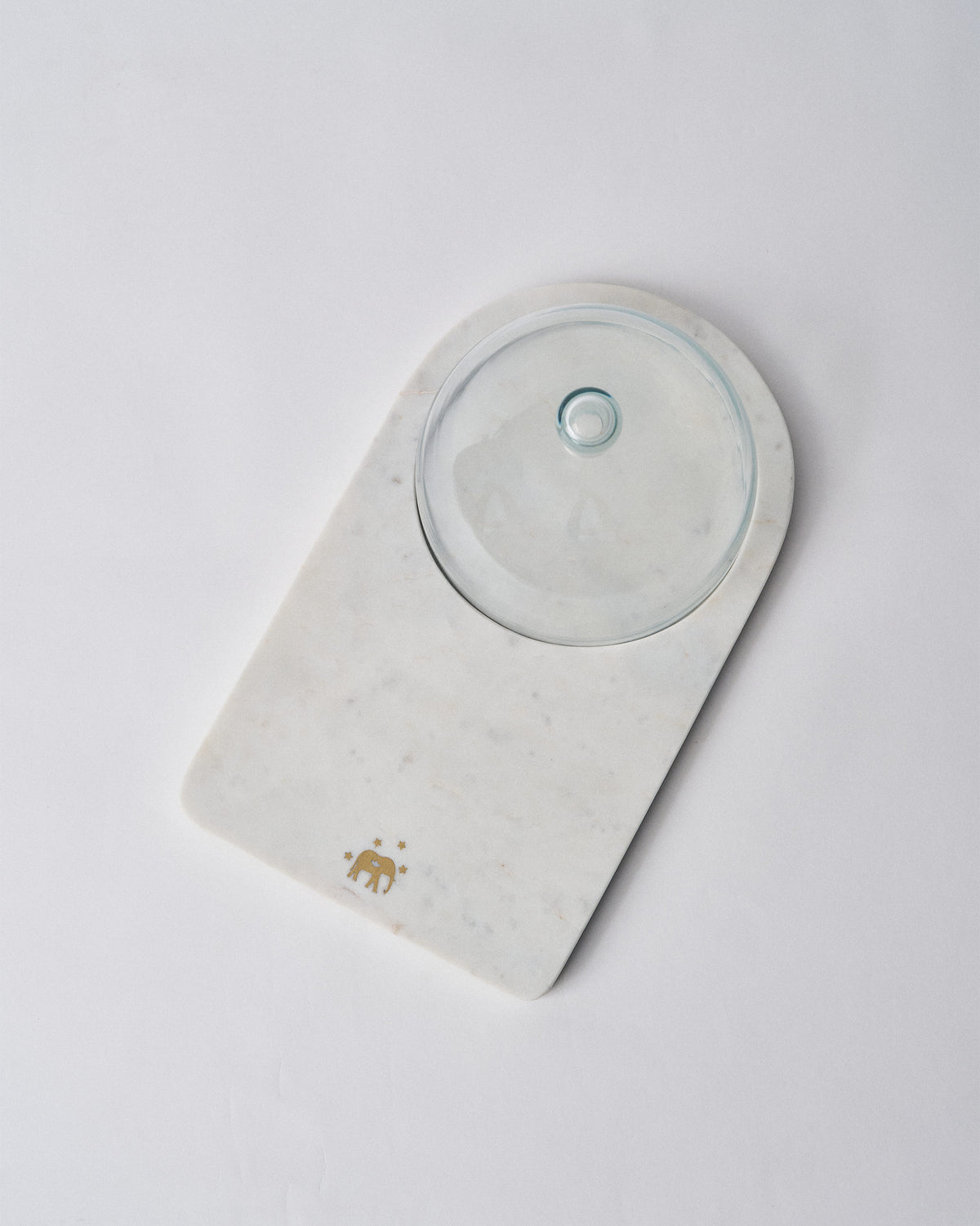 Overhead view of the marble Ele cheese cloche with glass dome and elephant motif.
