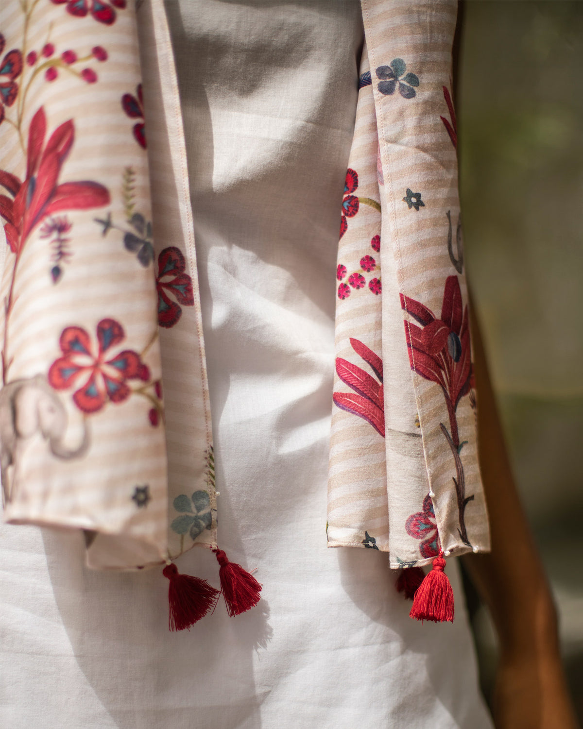 Close-up of the Cascade Scarf ends showing red tassels and floral print.