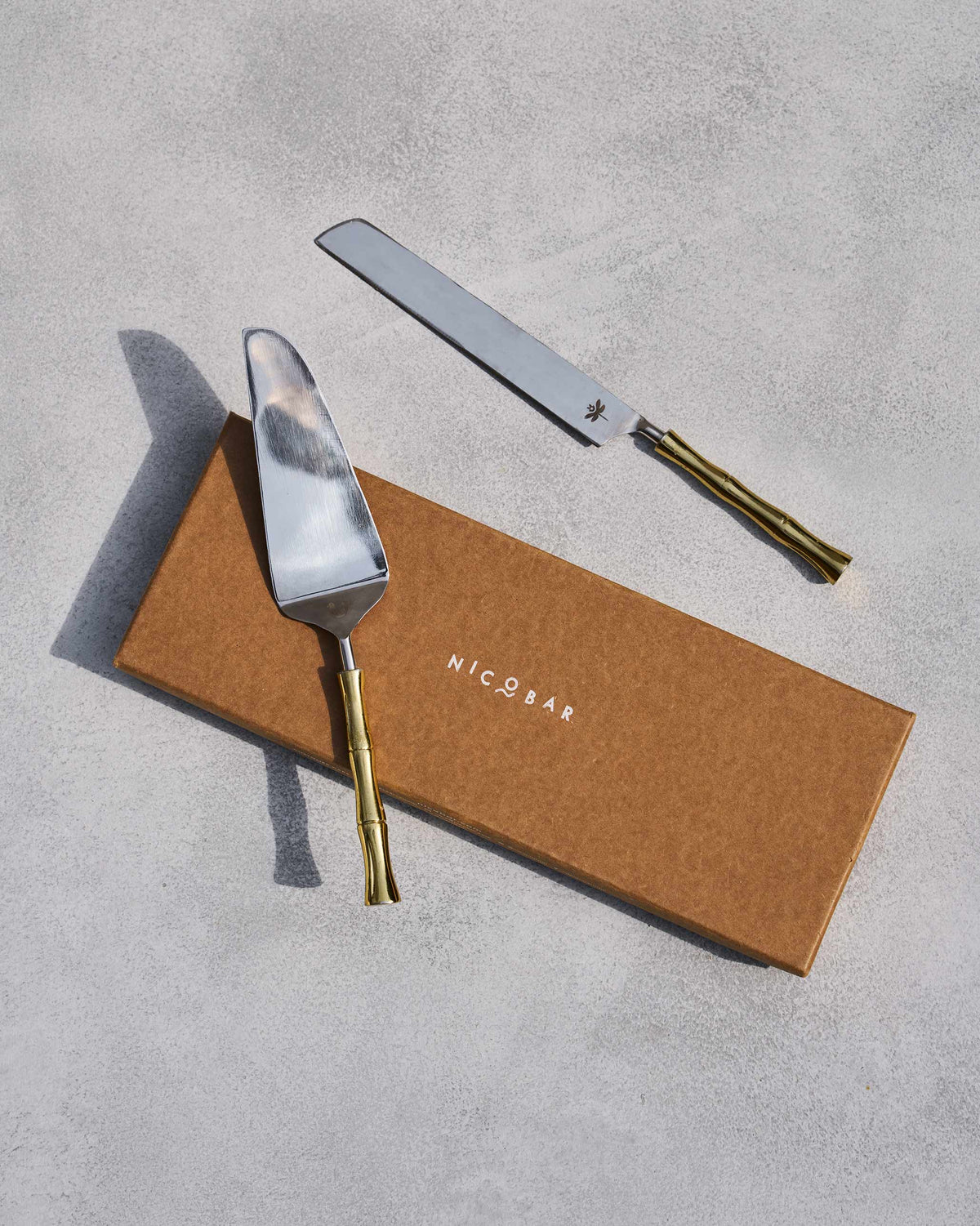 Sunrise cake knife and server on a Nicobar box.