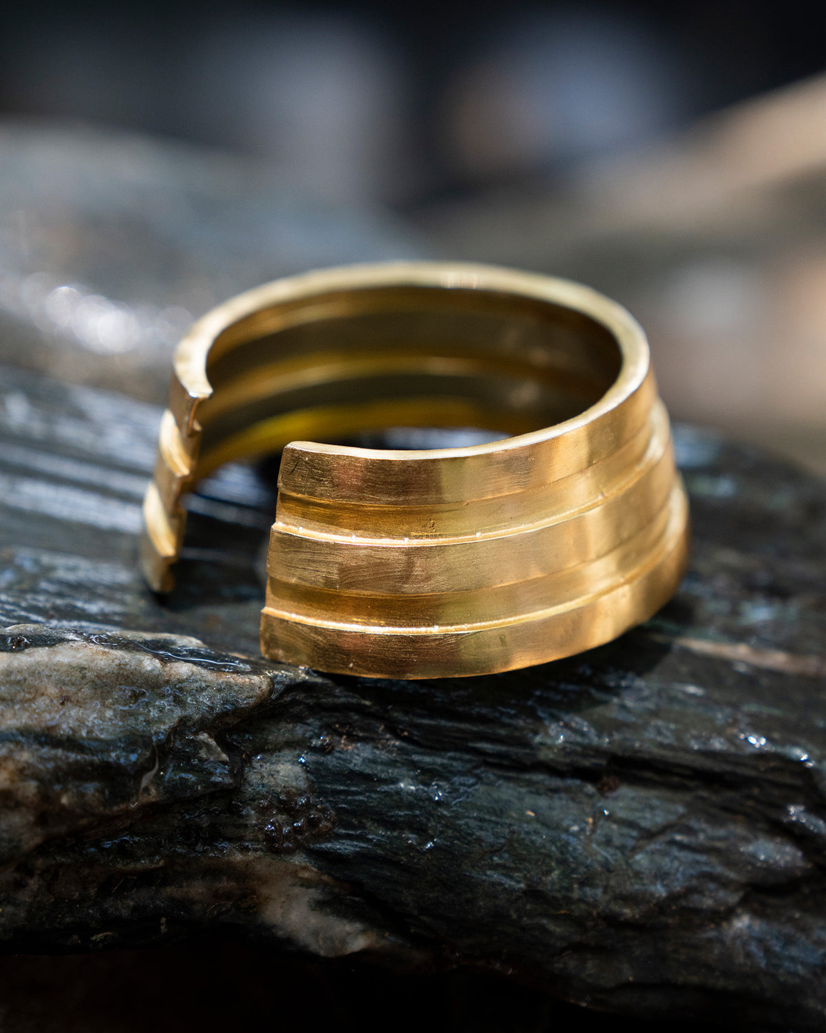 Close-up of a gold Ridge bangle showing stacked bands.