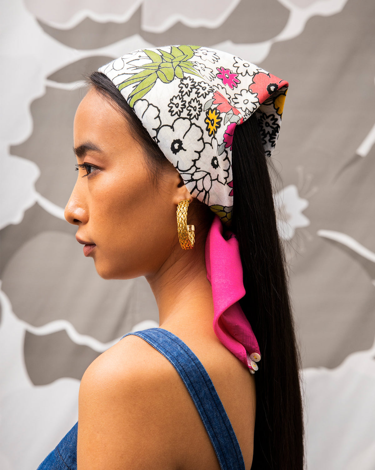Person wearing the Cascade Scarf tied over the head with a magenta edge.