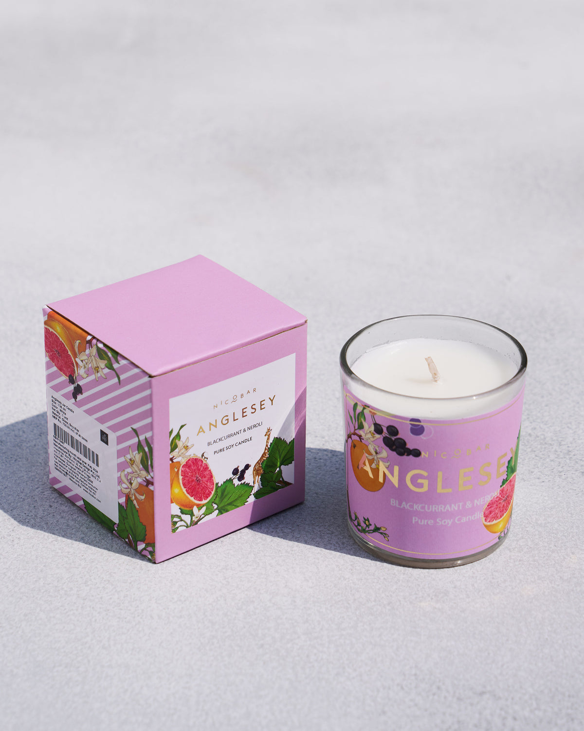 Anglesey jar candle beside its lilac box.