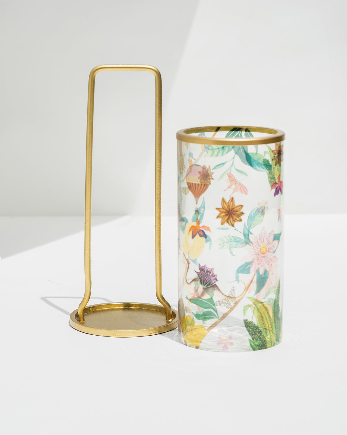 Gold frame and floral-print glass sleeve of the Wildflower lantern, shown separately.