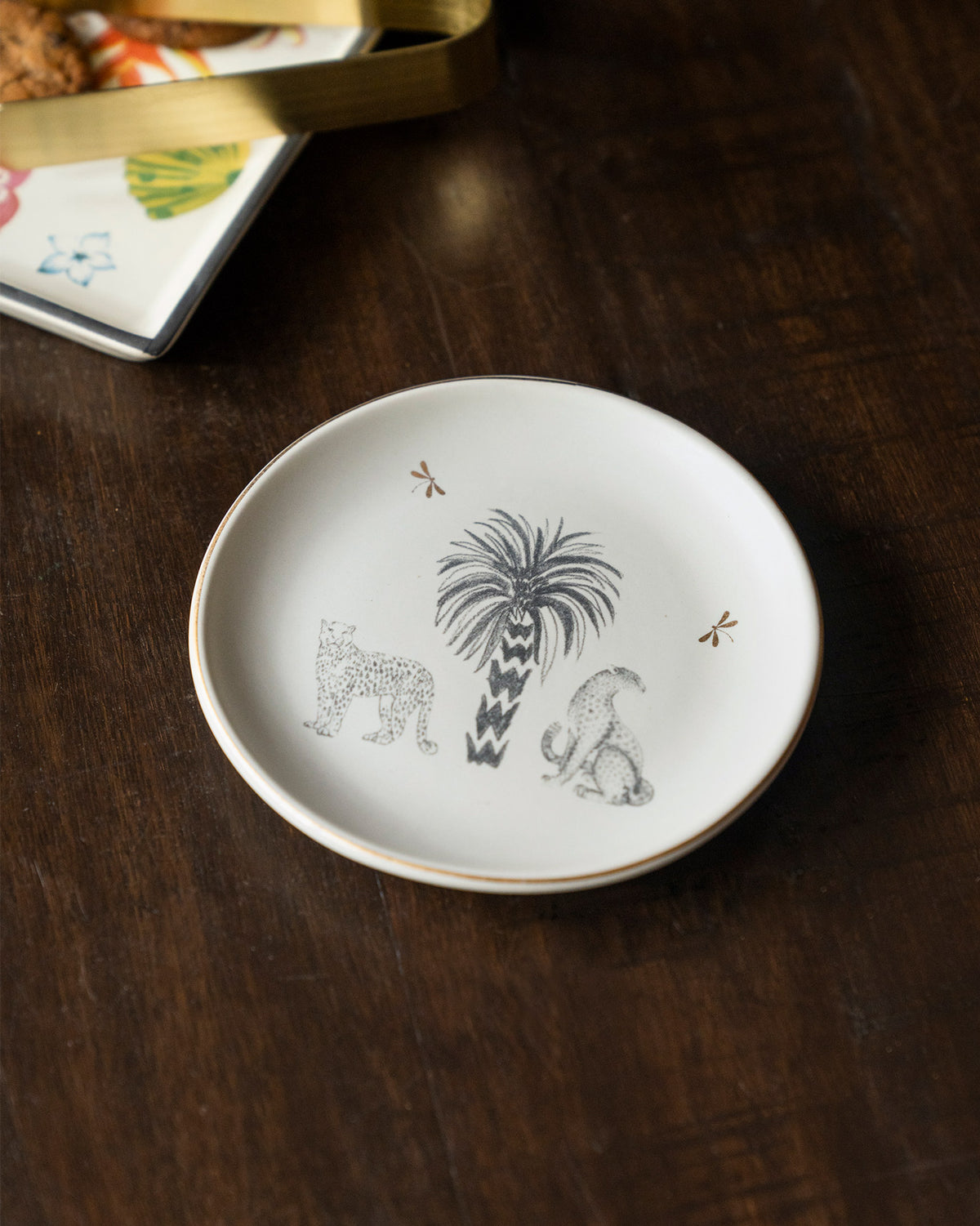 Periyar Tea Plate with a palm tree, a leopard and a seated animal.