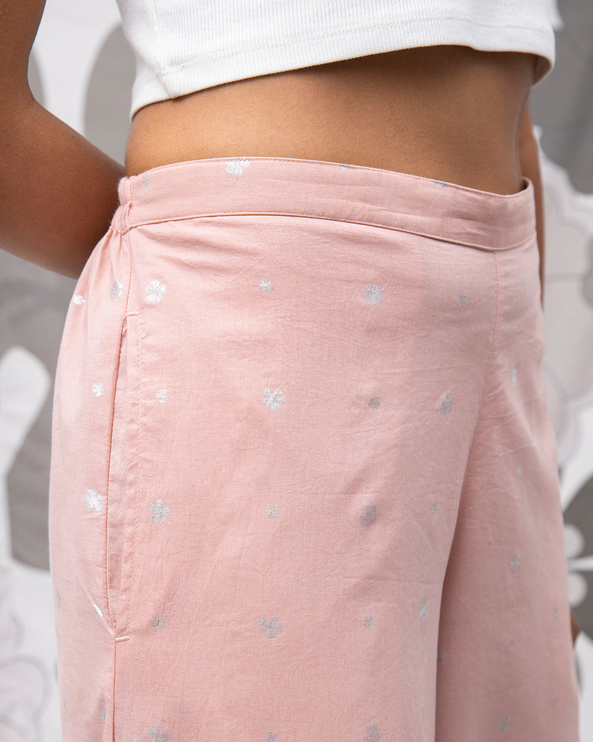 Close-up of pink Basic Pyjamas showing the small white dot print and waistband.
