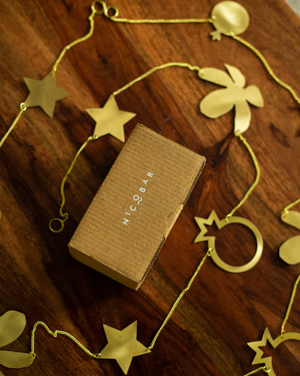Kachnaar Toran laid out on a wooden surface with gold stars and flowers.