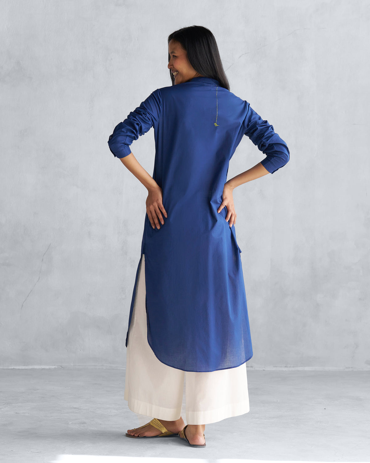 Back of a navy long kurta with side slits and a green parrot motif.