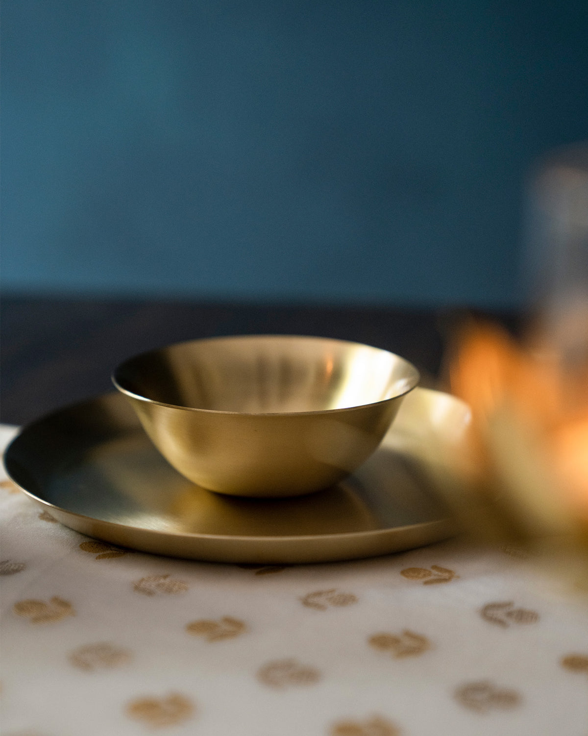 Brass Madhu katori nested on a matching brass plate.