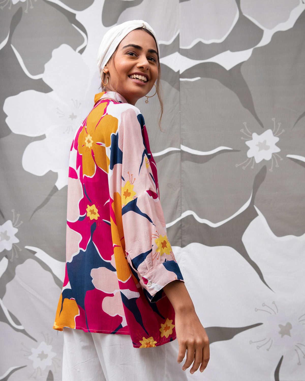 Side view of the Boxy Shirt in a pink and orange floral print worn by a person.