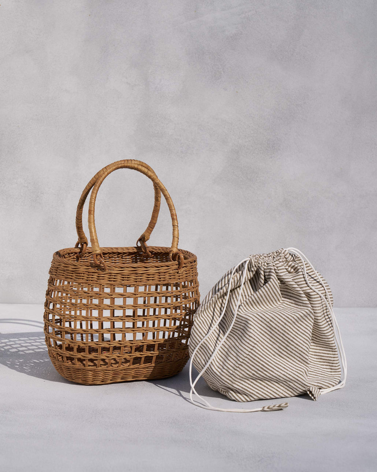 Khasi Lunch Basket beside its striped drawstring pouch.
