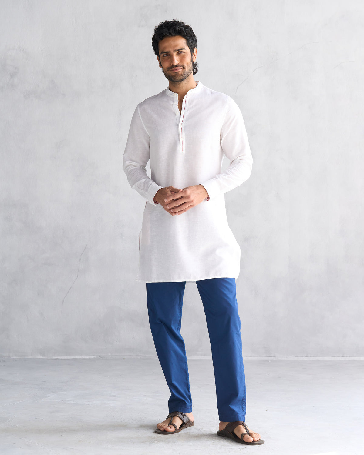 Person wearing a mid-thigh white Chandni Chowk kurta.