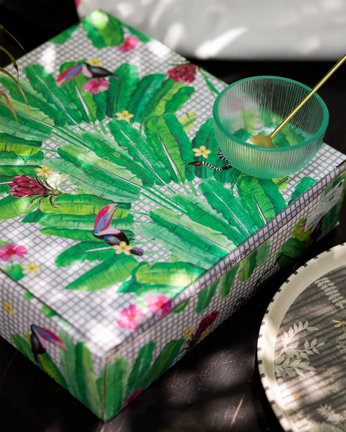 Periyar Chip & dip platter beside a box wrapped in banana leaf print.