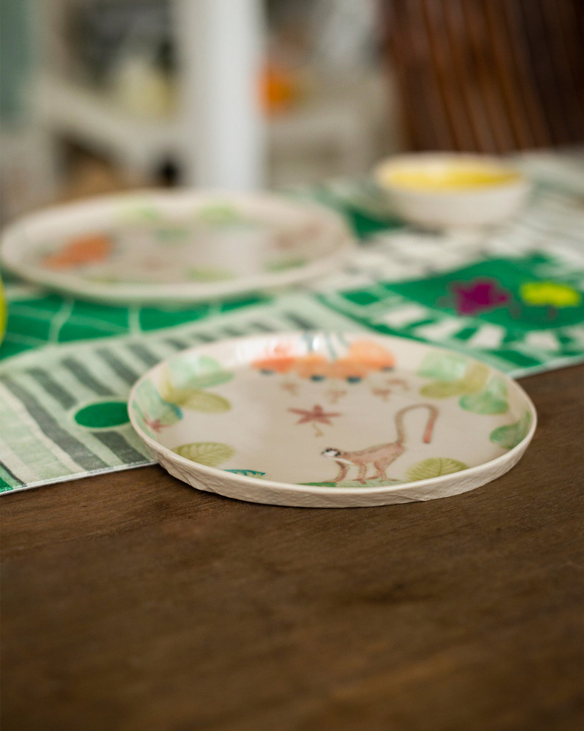 Mandovi dessert plate showing a monkey amid tropical foliage.