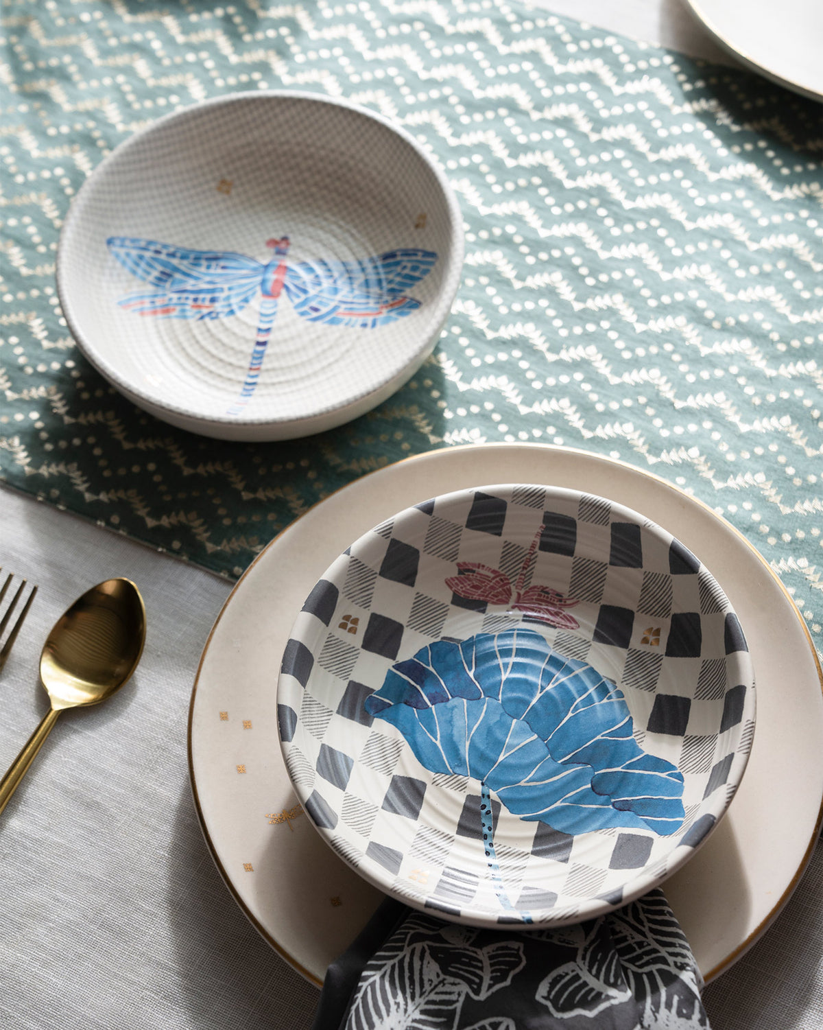 Nectar shallow bowls with dragonfly and leaf prints set on a dining table.