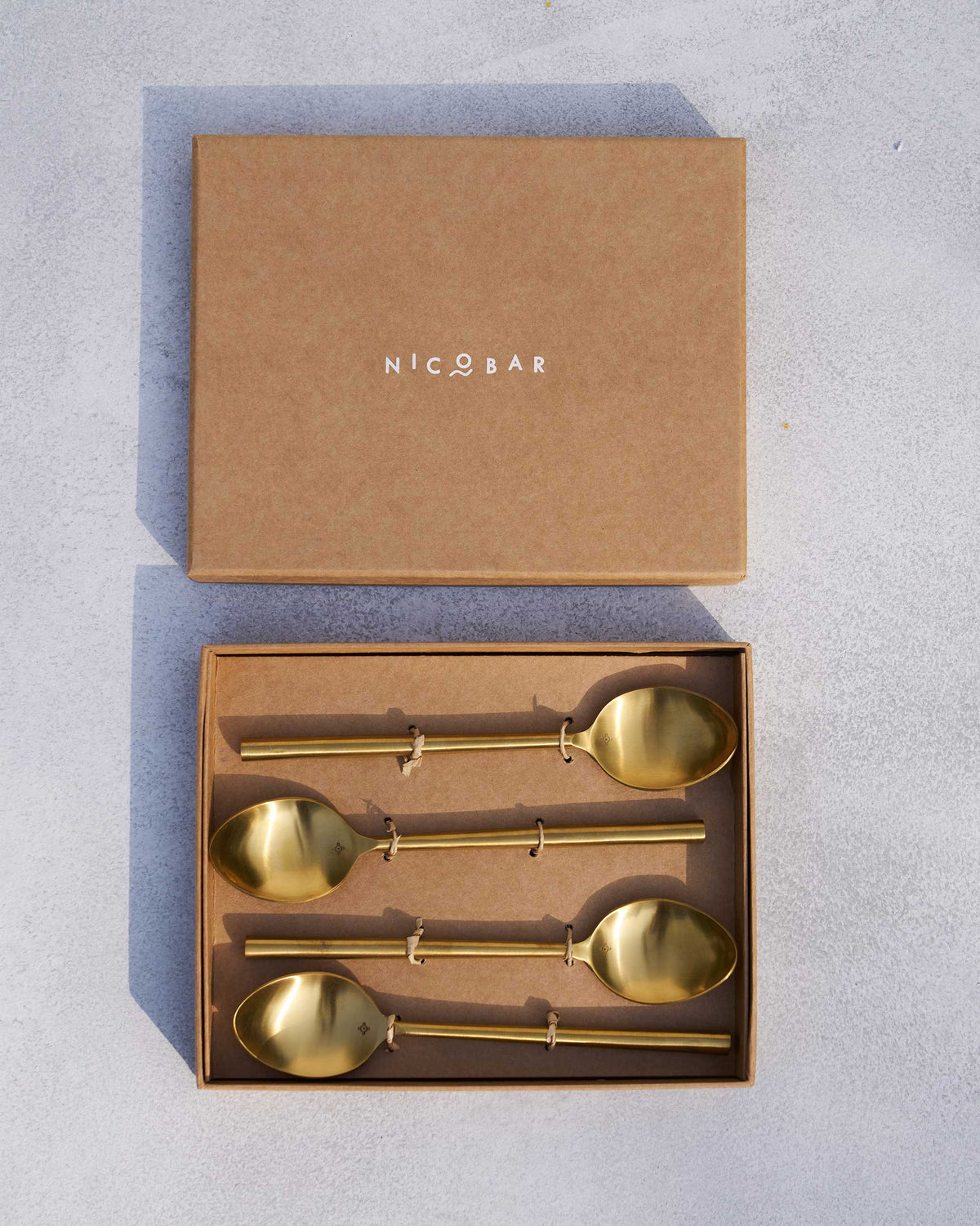 Sitara spoons packed in an open Nicobar kraft gift box.