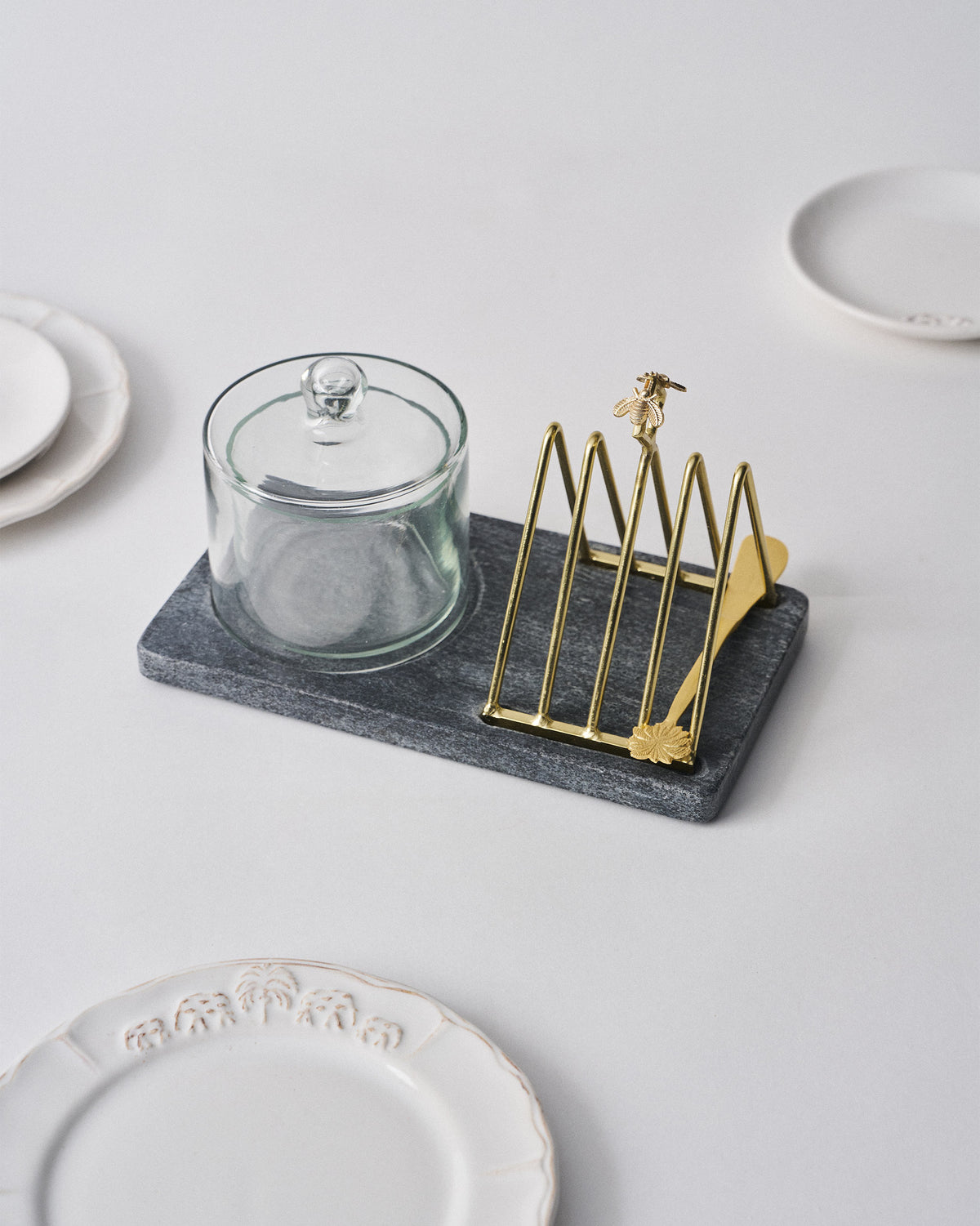 Mahi breakfast tray with glass butter dish and gold toast rack set for serving.
