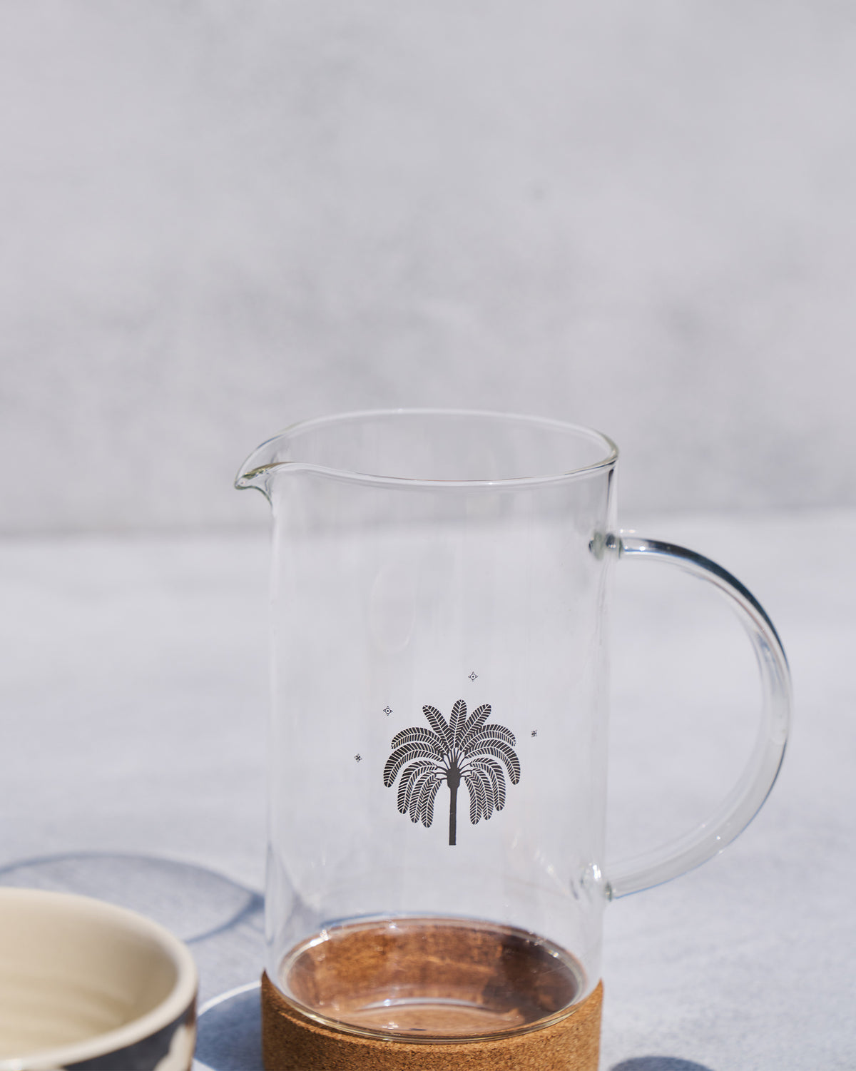 Clear Toddy French press carafe with a palm motif and cork base.