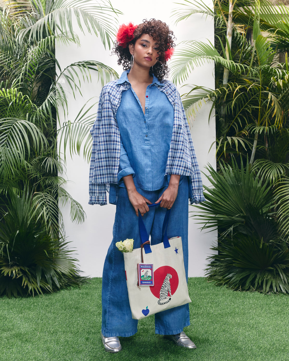 Person wearing a blue Mati shirt set with matching trousers.
