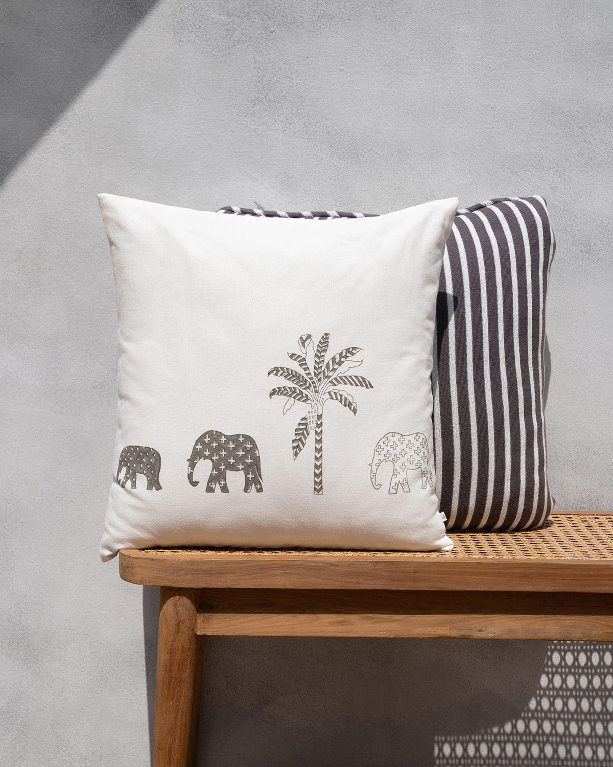 The Ele Palm Cushion Cover with a palm and three elephants.
