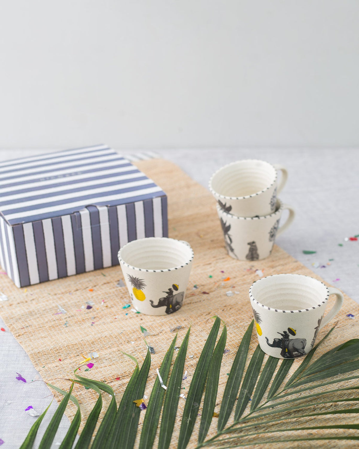 Haathi Sher espresso mugs from the Tea and Coffee Set on a woven mat.