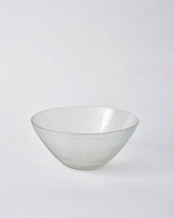 Aire Serving Bowl in clear glass with fine vertical ridges.