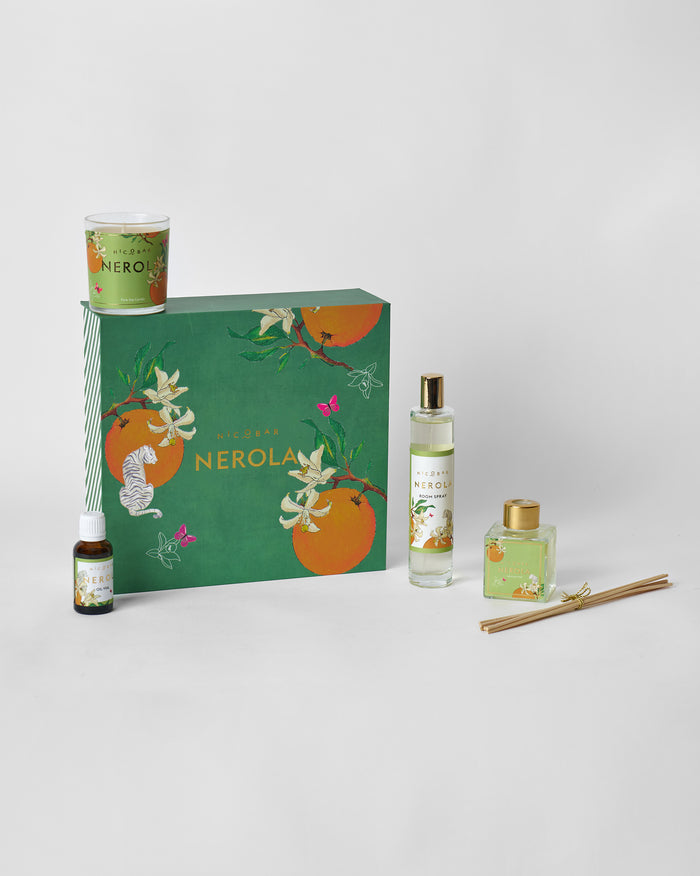 Nerola gift set with candle, room spray, oil vial, and reed diffuser around the green box.