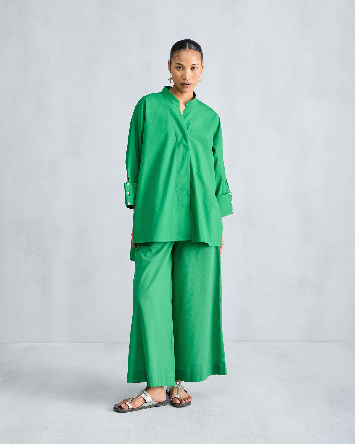 Bright green wide-leg pyjamas worn with a matching long green shirt.