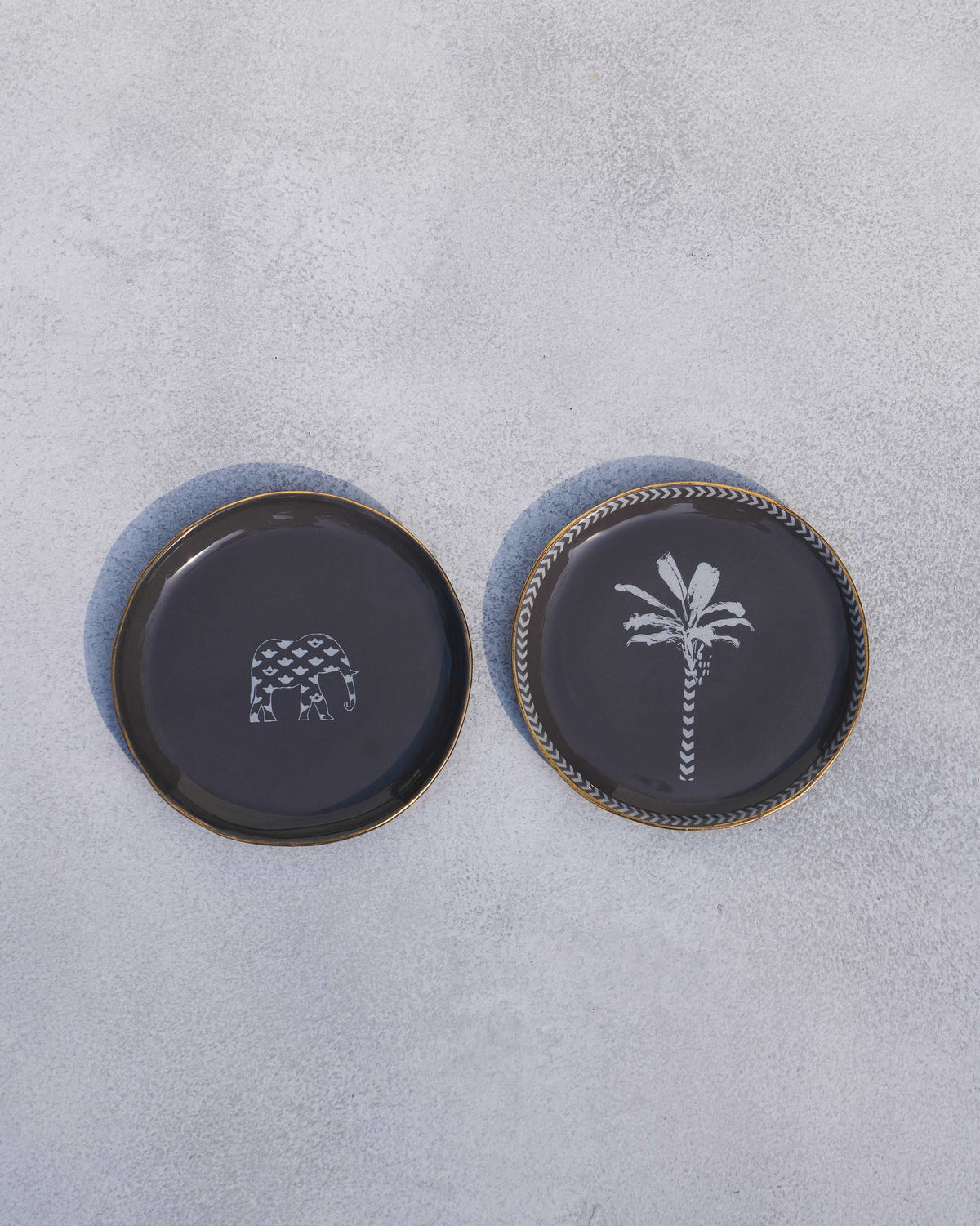 The pair of charcoal Coastal Tea Plates laid flat.