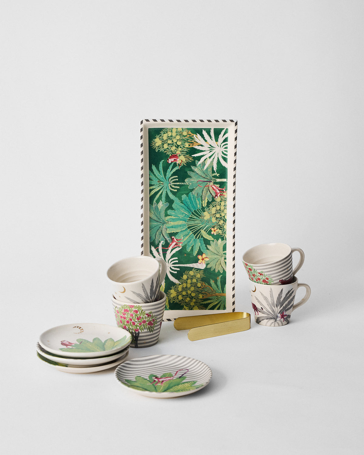 Ceylon Trail Set laid out with plates, mugs and a tray.
