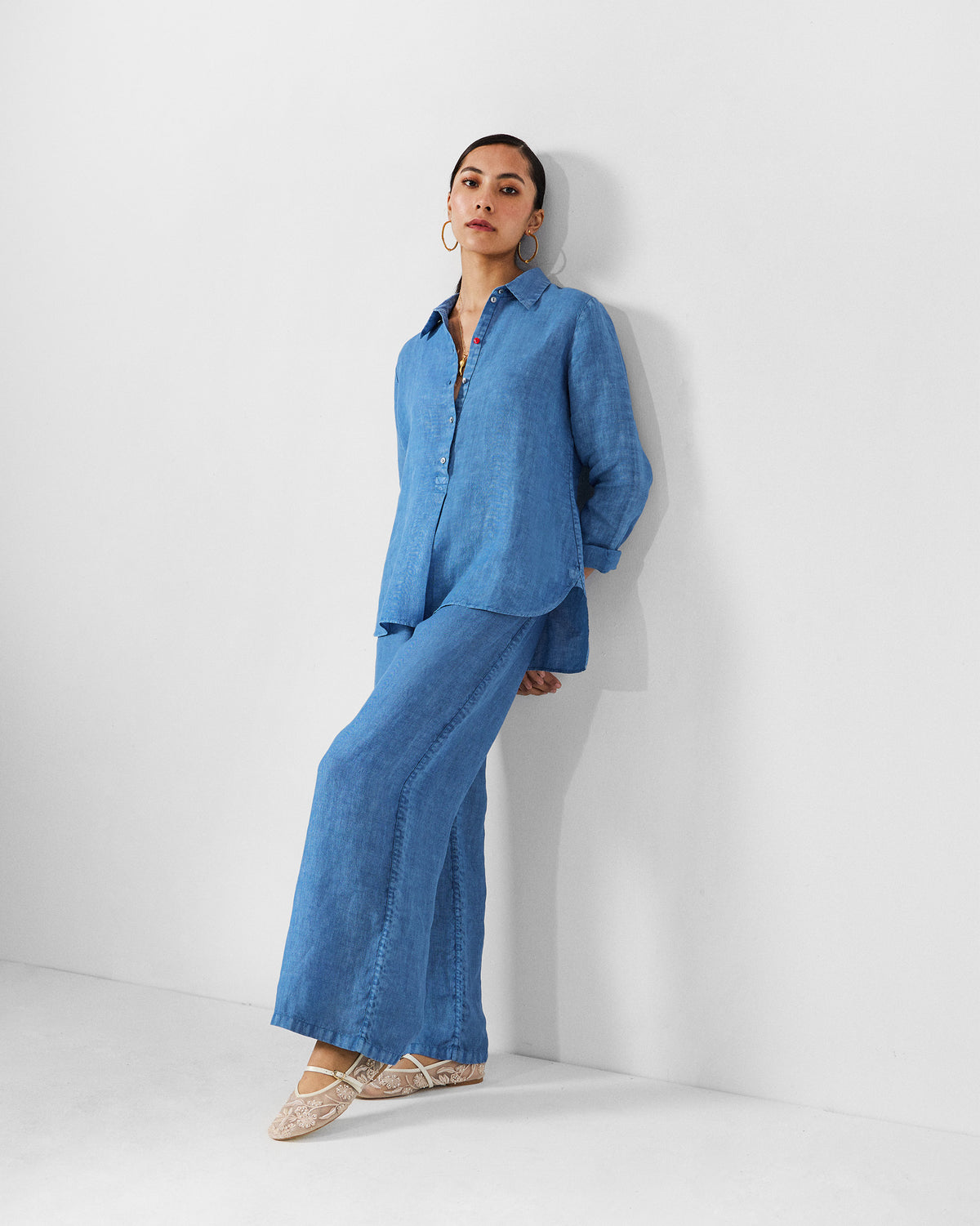 Person wearing a blue Mati shirt set with matching trousers.