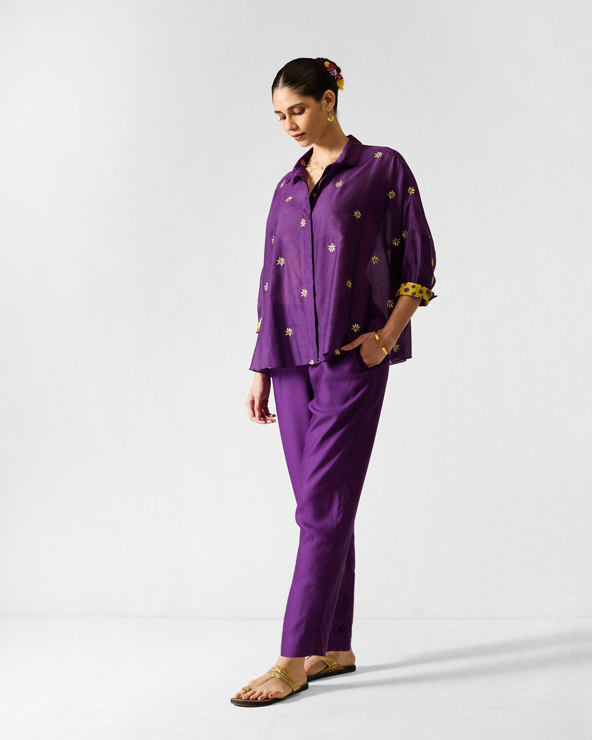 Person wearing purple Darjeeling pants with a tapered ankle fit.