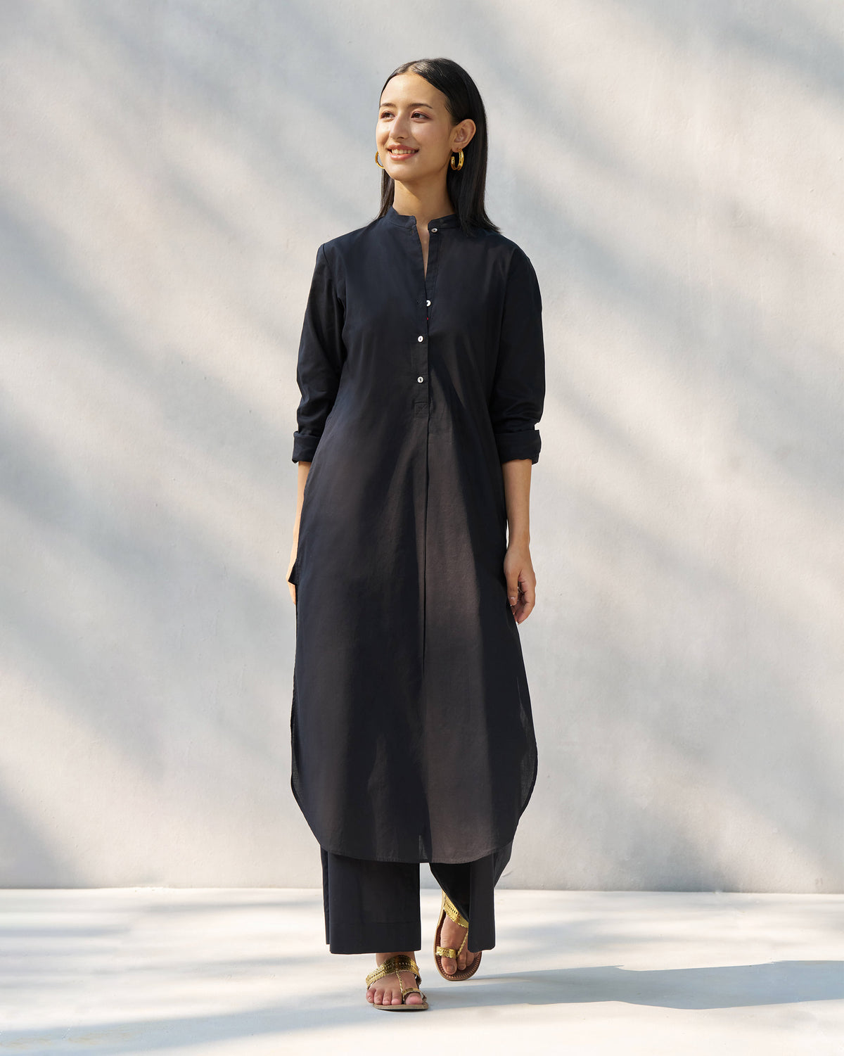 Person wearing a black long kurta with a mandarin collar.
