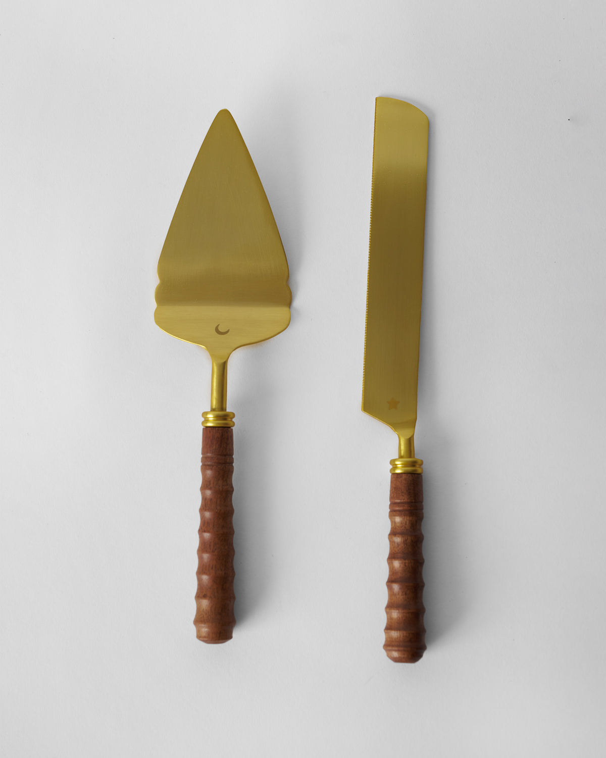 Gold cake knife and server set with dark ribbed wood handles.