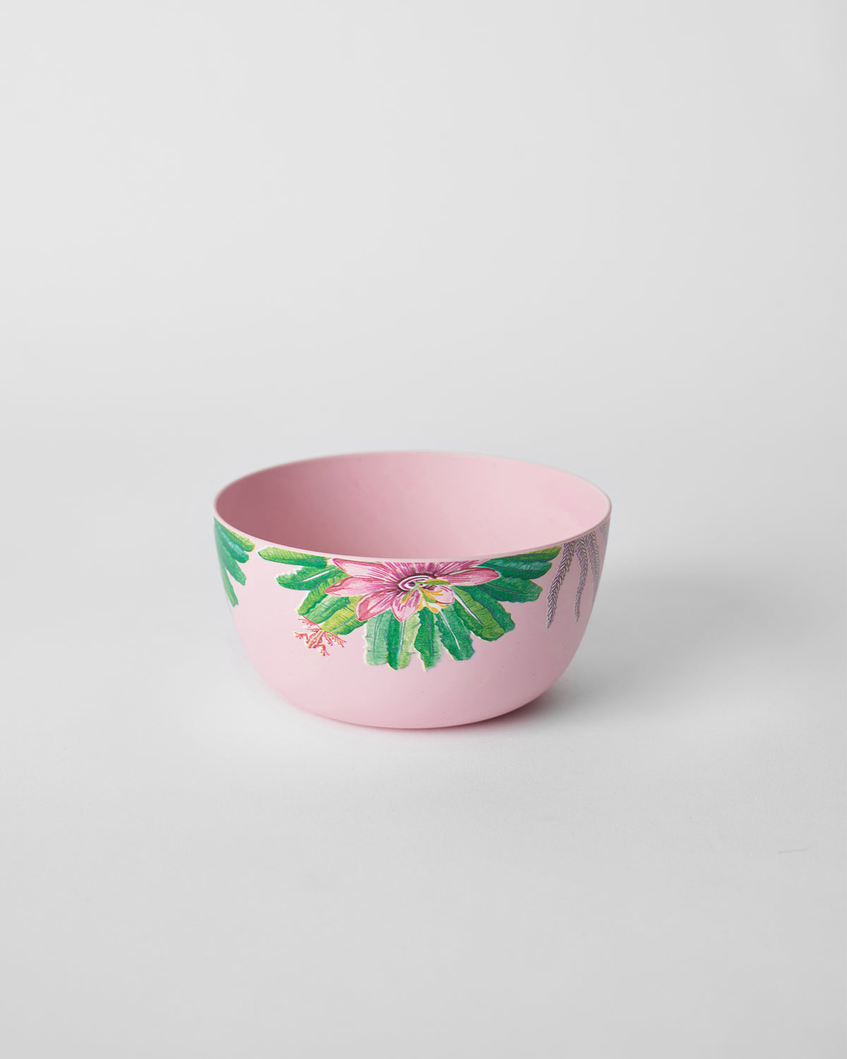 Pink Toucan bamboo cereal bowl with a large pink flower and green leaves.