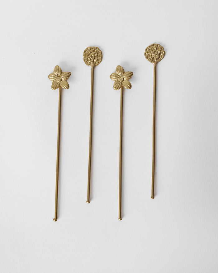 Set of four Bloom stirrers, two with flower heads and two with round textured tops.