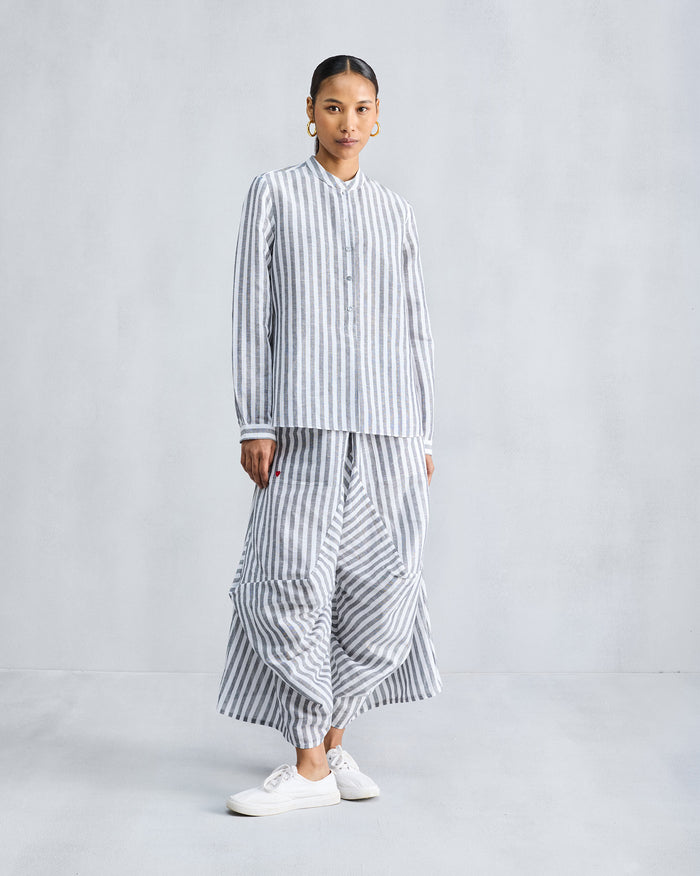Charcoal and white striped Yoka Trousers worn with a matching shirt.