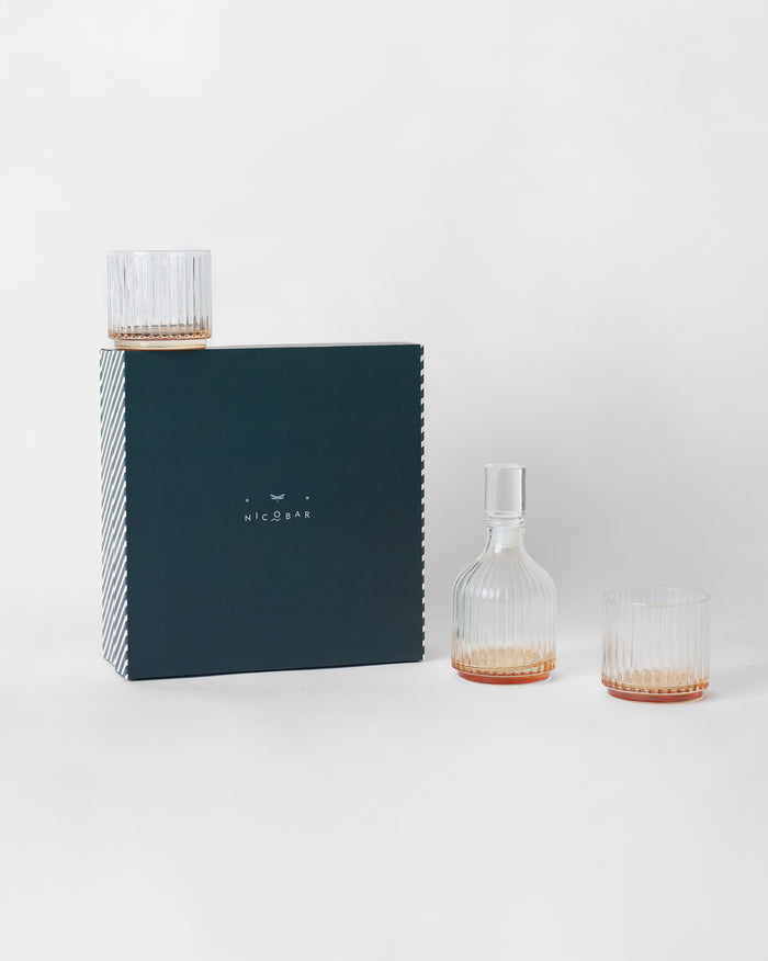 Tarang Bar Gift Set decanter and ribbed glasses beside its navy box.
