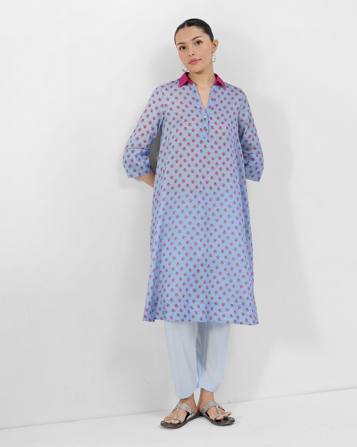 Person wearing an ice blue Kovvur Kurta Set with a fuchsia collar.