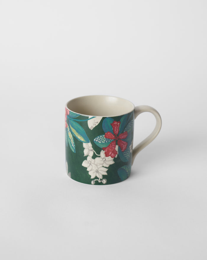 Deep green straight mug with red buransh blooms and a cream handle.