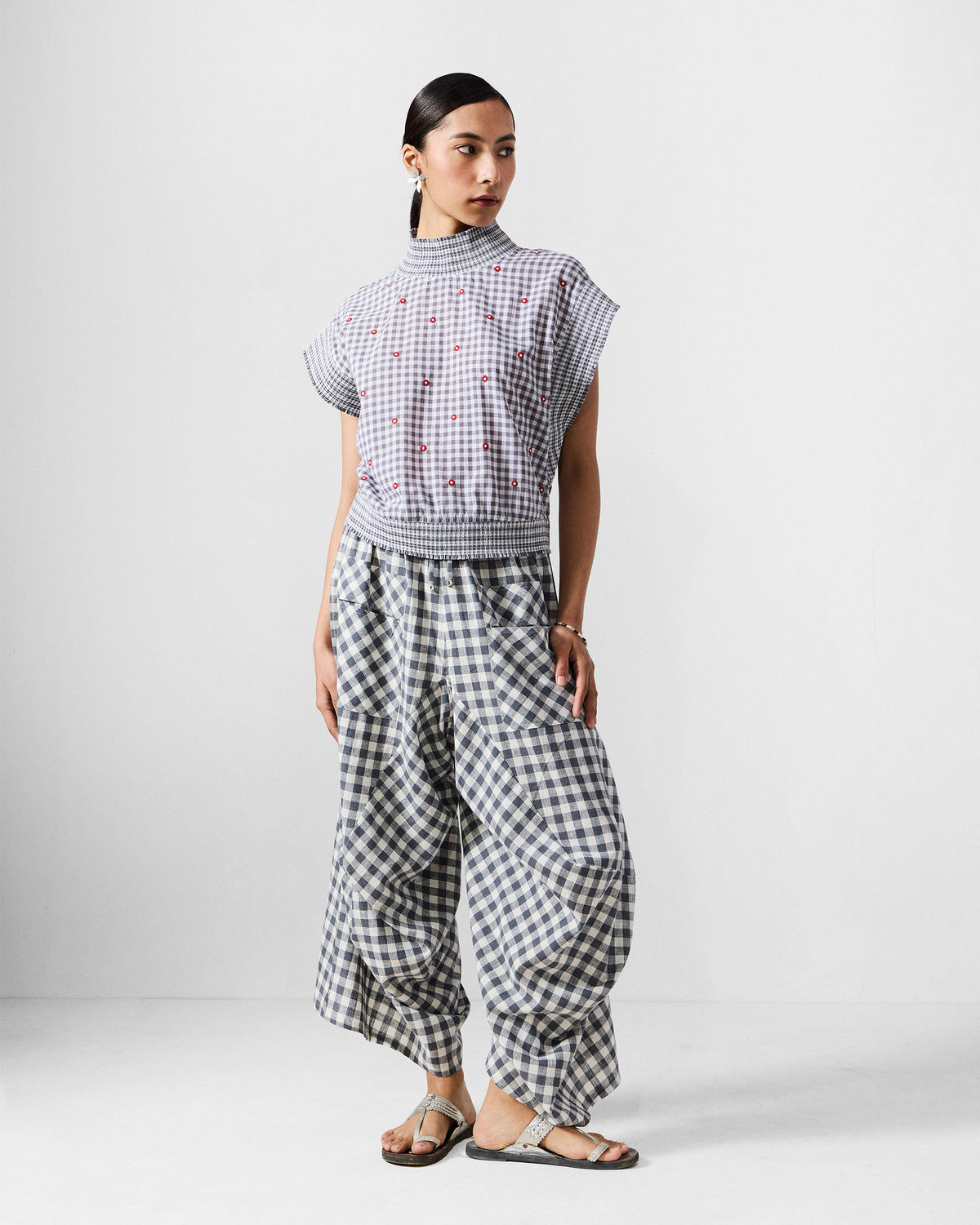 Person wearing the Lehar Top Set in grey gingham with a smocked high neck and waistband.