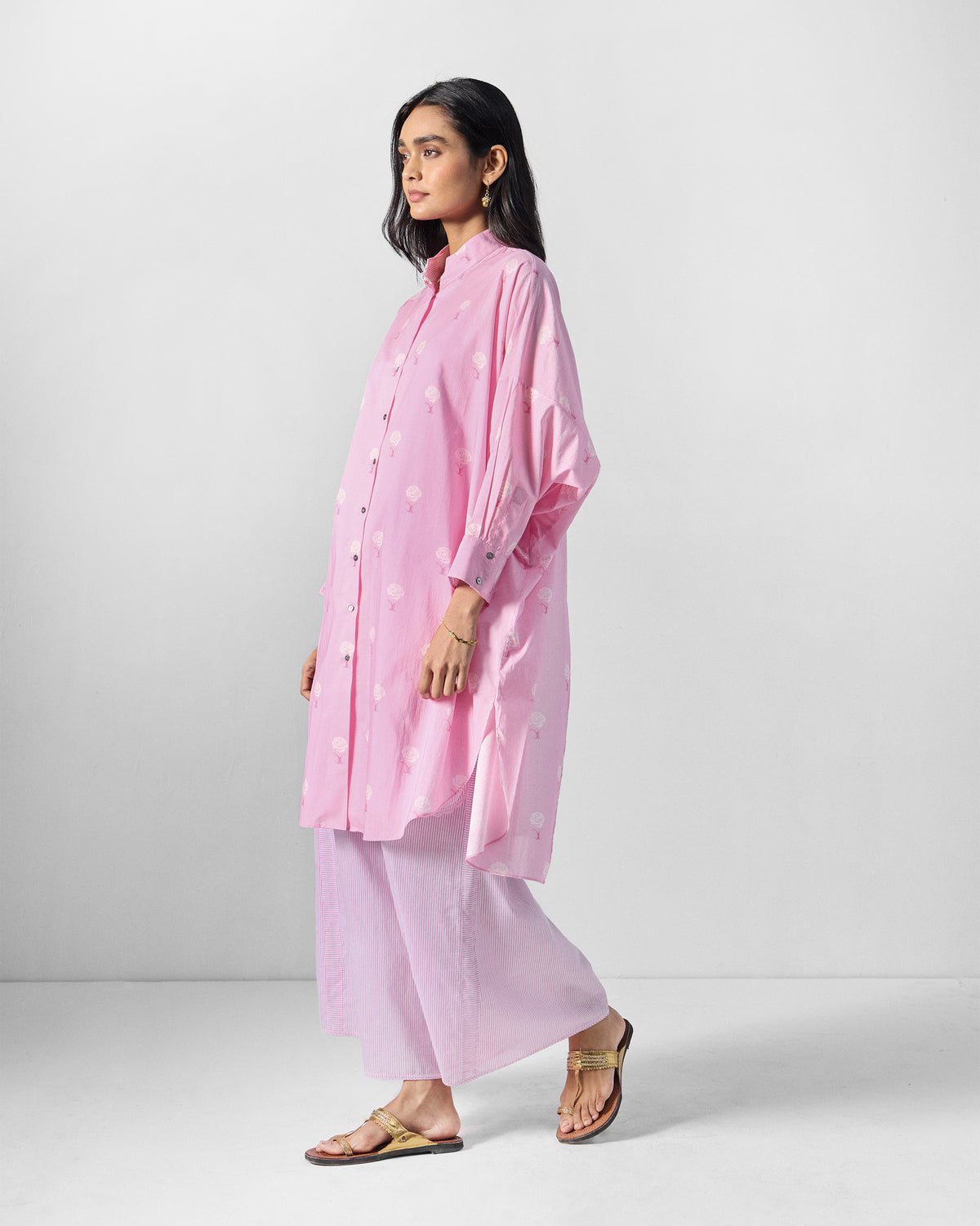 Side view of a pink floral tunic set with wide-leg pants.
