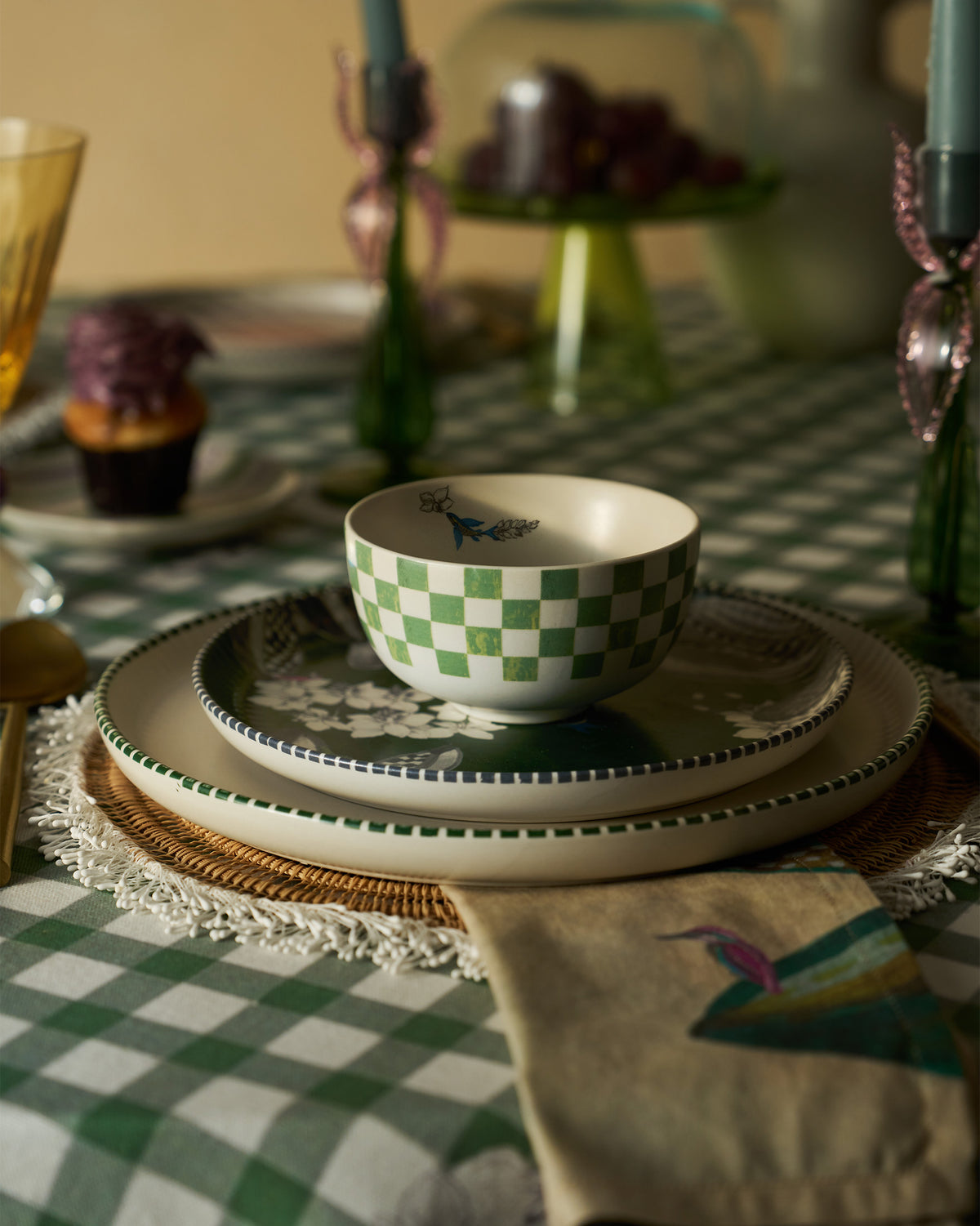 Green checked Reesha katori stacked on matching plates in a table setting.