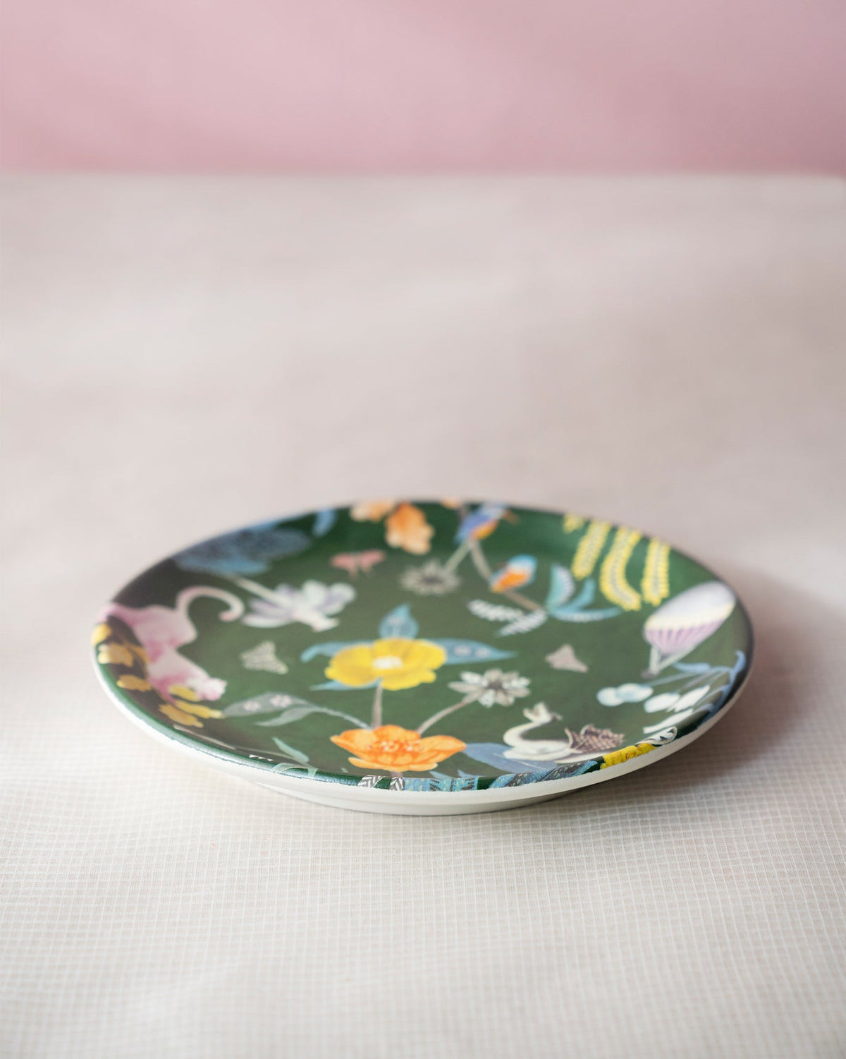 Myra quarter plate with a dark green jungle print and yellow flowers.