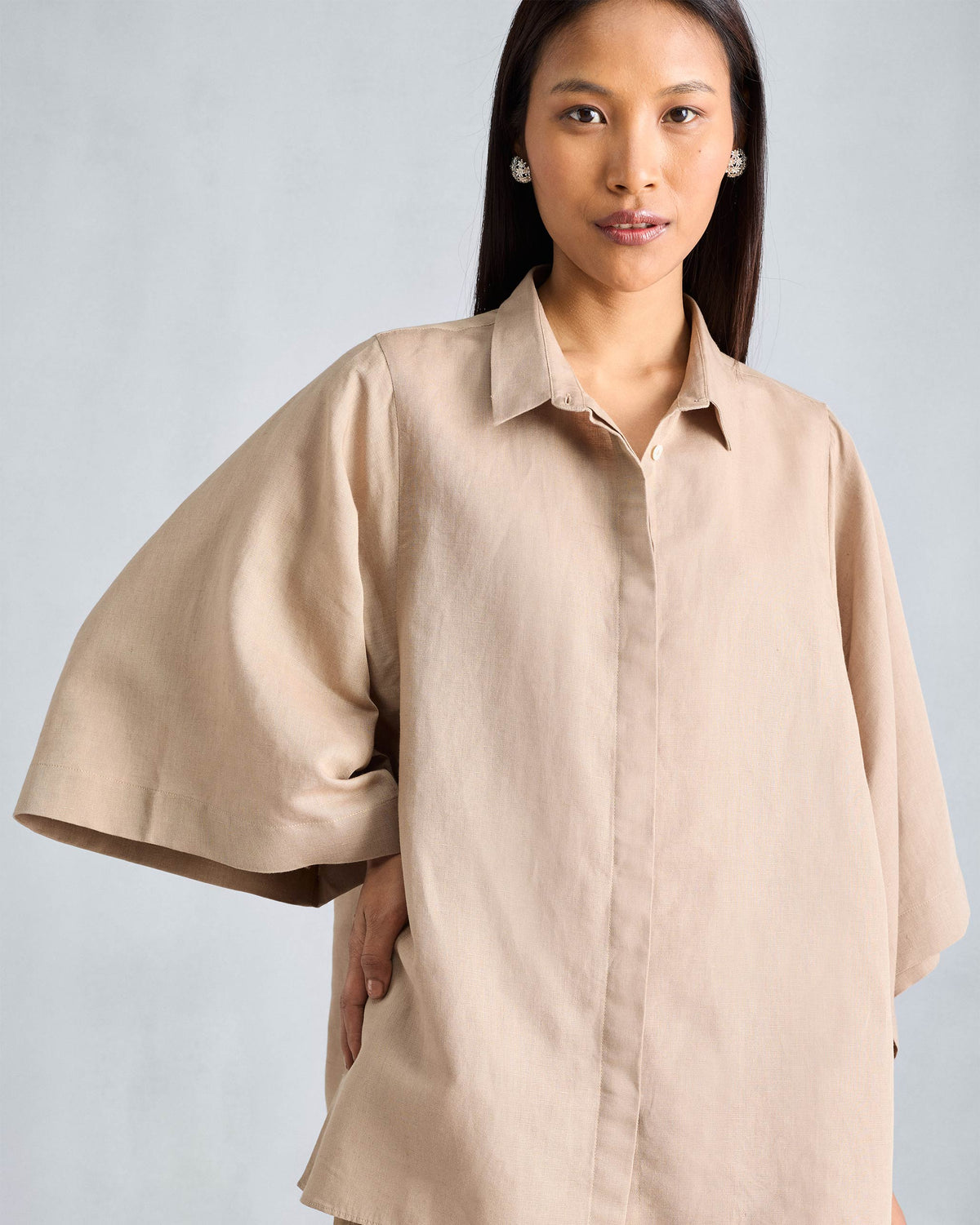 Beige Drop Armhole shirt with a pointed collar and wide flared sleeves.